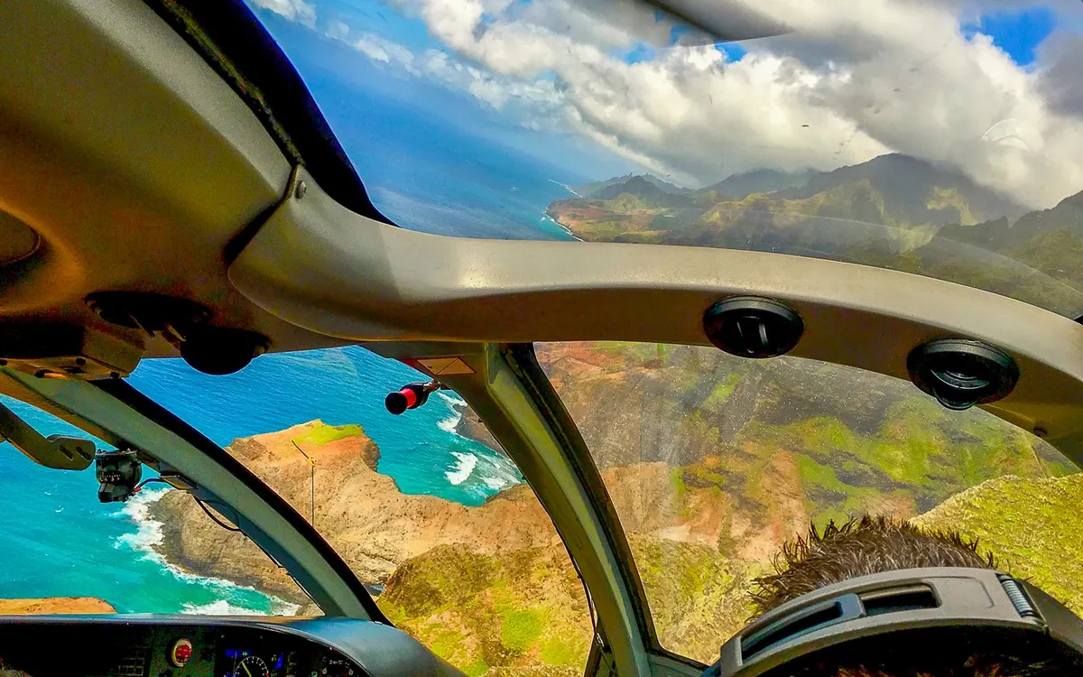 The view from a helicopter cabin window over the Maui coast