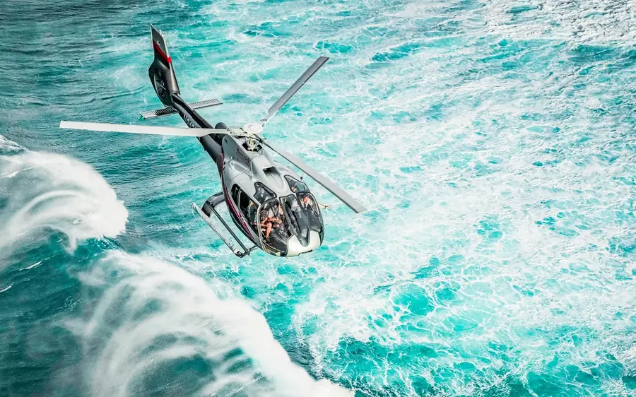 A tour helicopter over the water on the Road to Hana flight, Maui